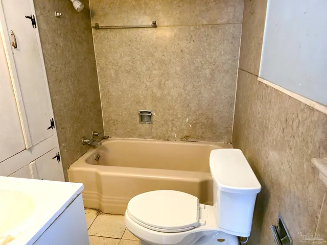a bathroom with a sink a toilet a bathtub and a shower