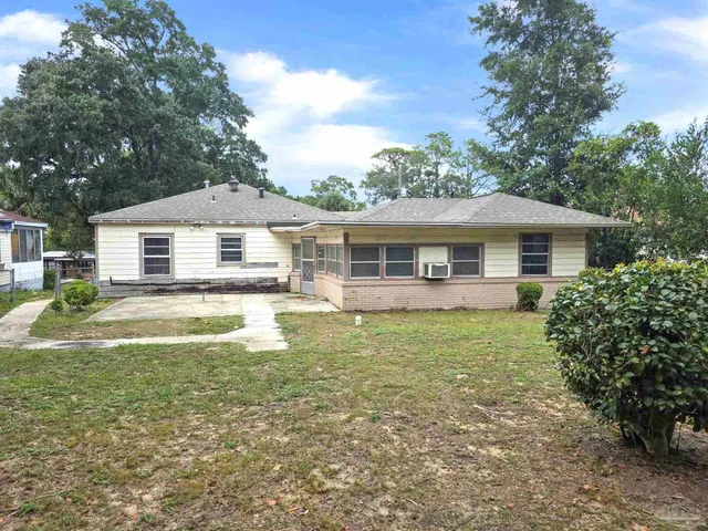 a swimming pool with an outdoor space and seating area