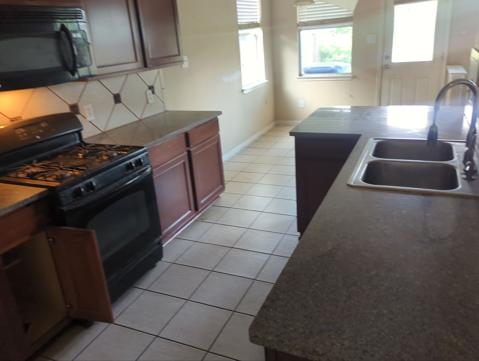 21850 Catoosa Drive Spring, TX 77388 - Photo 8 of 15 a kitchen with granite countertop a stove and a refrigerator