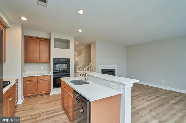 a kitchen with a stove a sink and a refrigerator