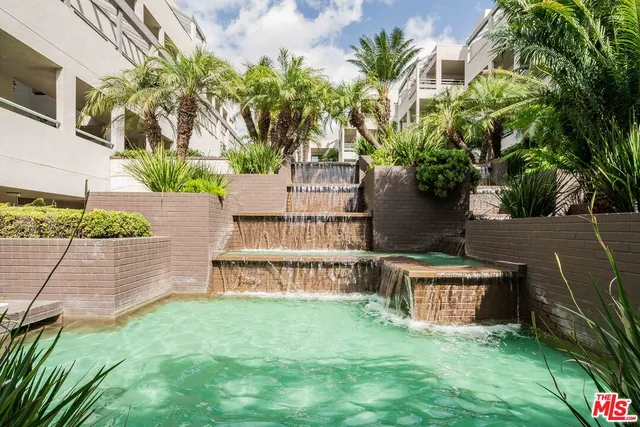 front view of house with a yard and potted plants