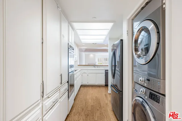 a view of a storage and utility room with a washer dryer