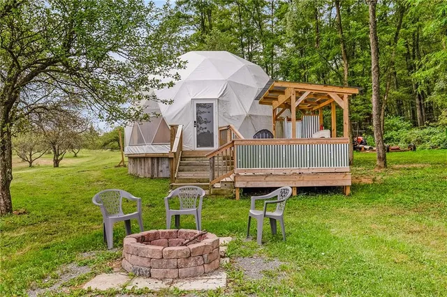 a view of swimming pool with a yard in front of it