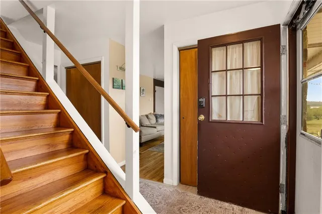 a living room with furniture wooden floor and a large window