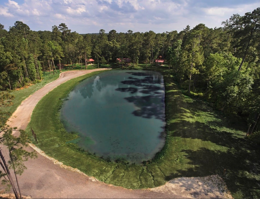 11-24-79 Sanctuary Road Huntsville, TX 77340 - Photo 23 of 26 a view of a lake in middle of the house