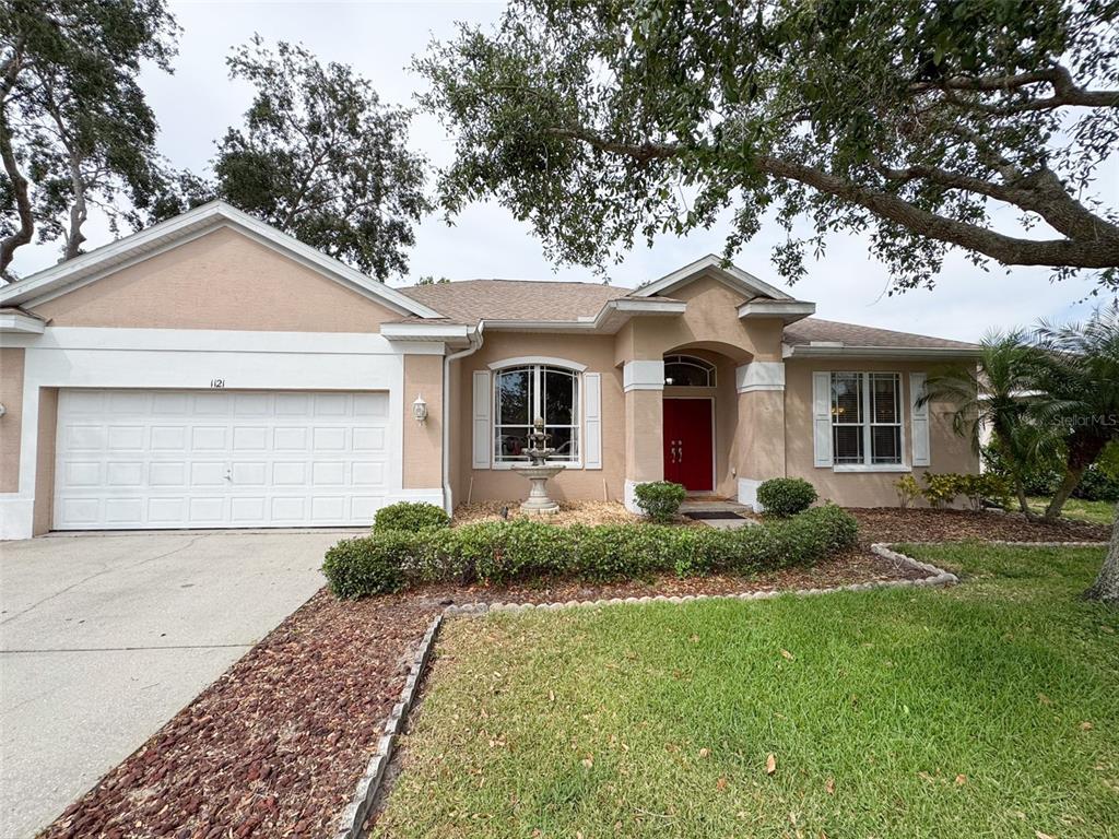 1121 Riveredge Drive Tarpon Springs, FL 34689 - Photo 1 of 1 front view of a house with a yard