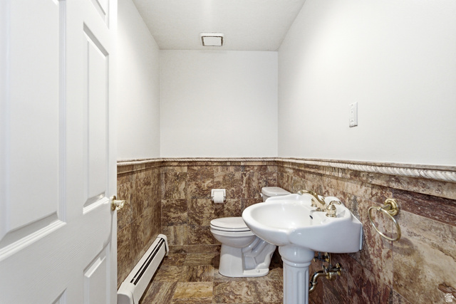 3535 Homestead Road Park City, UT 84098 - Photo 51 of 81 Pedestal sink with brass-finish faucet, toilet, and marble-look wainscoting