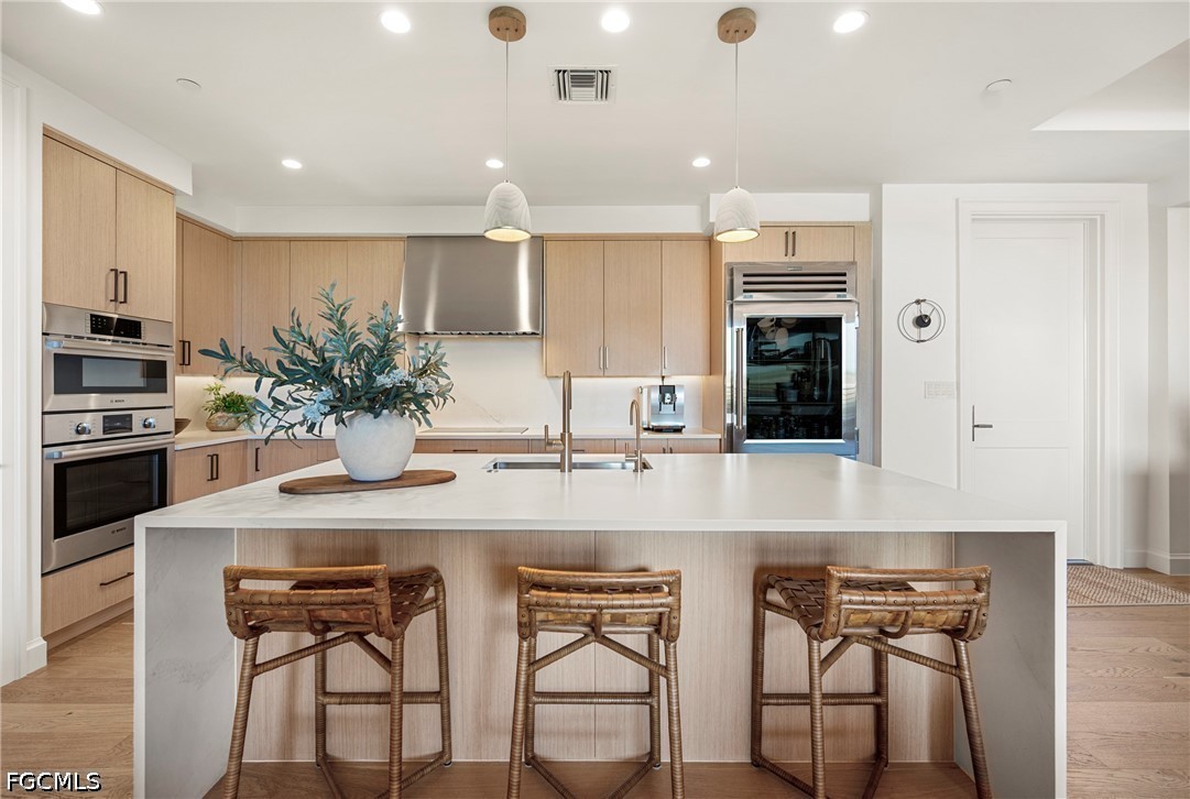 1115 Central Avenue, Unit 443 Naples, FL 34102 - Photo 2 of 40 a kitchen with stainless steel appliances kitchen island granite countertop a table and chairs in it