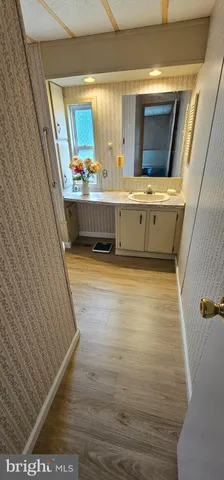 a bathroom with a sink a mirror and bathtub