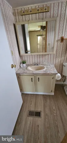 a view of a living room and bathroom with a tub