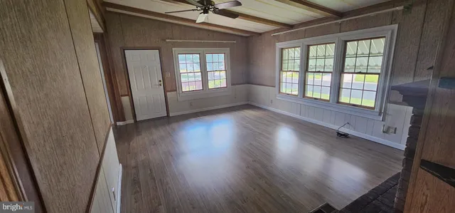 wooden floor in an empty room with a window