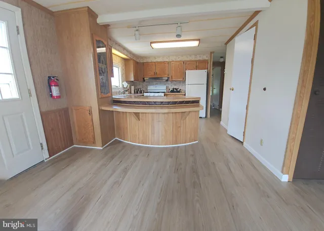 a view of kitchen with cabinets and wooden floor
