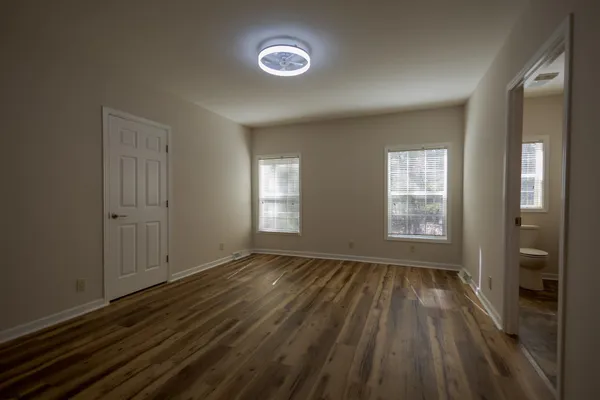 wooden floor in an empty room with a window