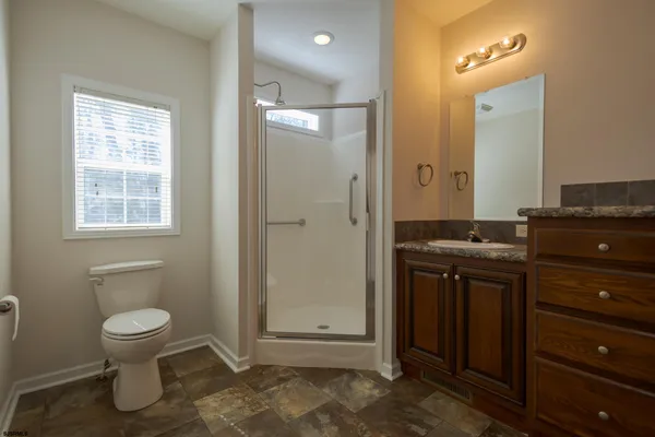 a bathroom with a toilet a sink and shower