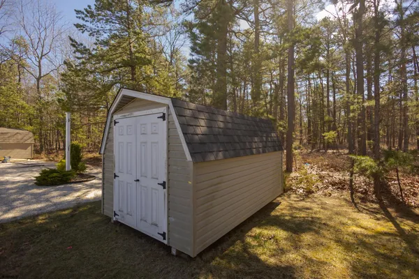 a view of a wooden door and a yard