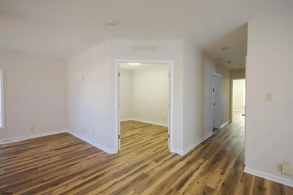 a view of hallway with wooden floor