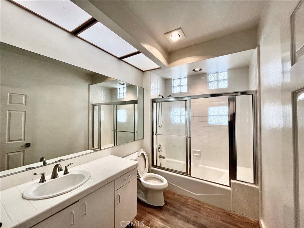 12211 Idaho Avenue, Unit 101 Los Angeles, CA 90025 - Photo 13 of 21 a bathroom with a toilet a sink and a mirror