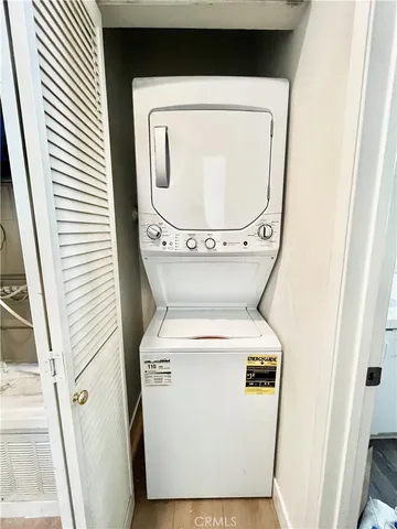 a view of cabinet with mirror and closet