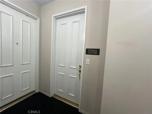 a view of a big room with wooden floor and a window