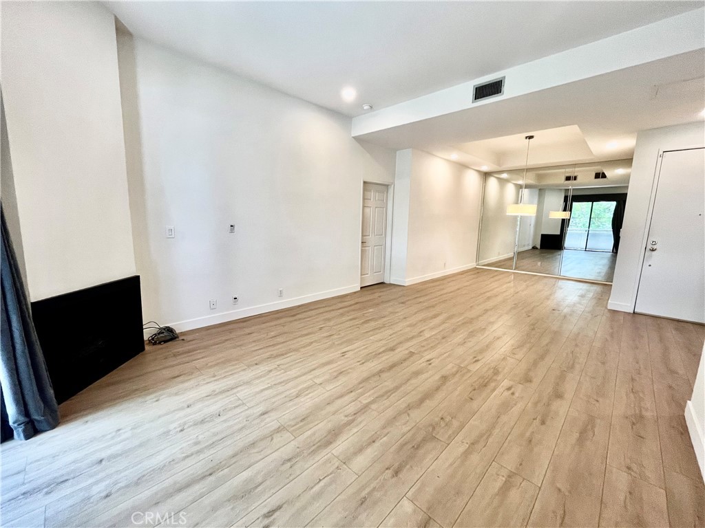12211 Idaho Avenue, Unit 101 Los Angeles, CA 90025 - Photo 7 of 21 a view of a big room with wooden floor and a window