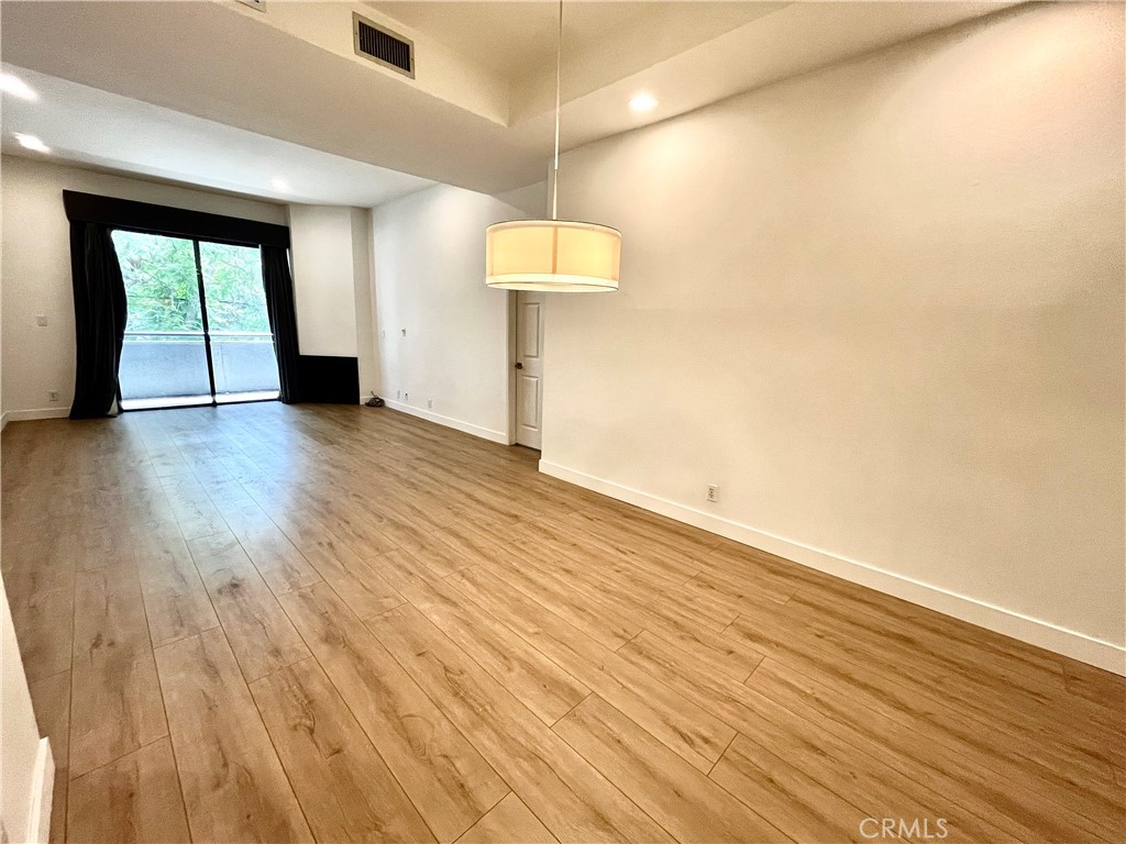 12211 Idaho Avenue, Unit 101 Los Angeles, CA 90025 - Photo 8 of 21 a view of a room with wooden floor and a window