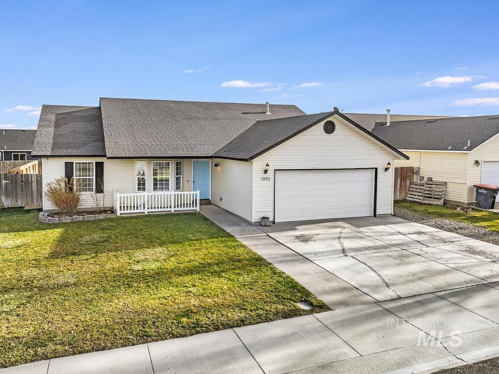 1393 Valencia Street Twin Falls, ID 83301 - Photo 1 of 44 View of front facade with concrete driveway, an attached garage, and a shingled roof