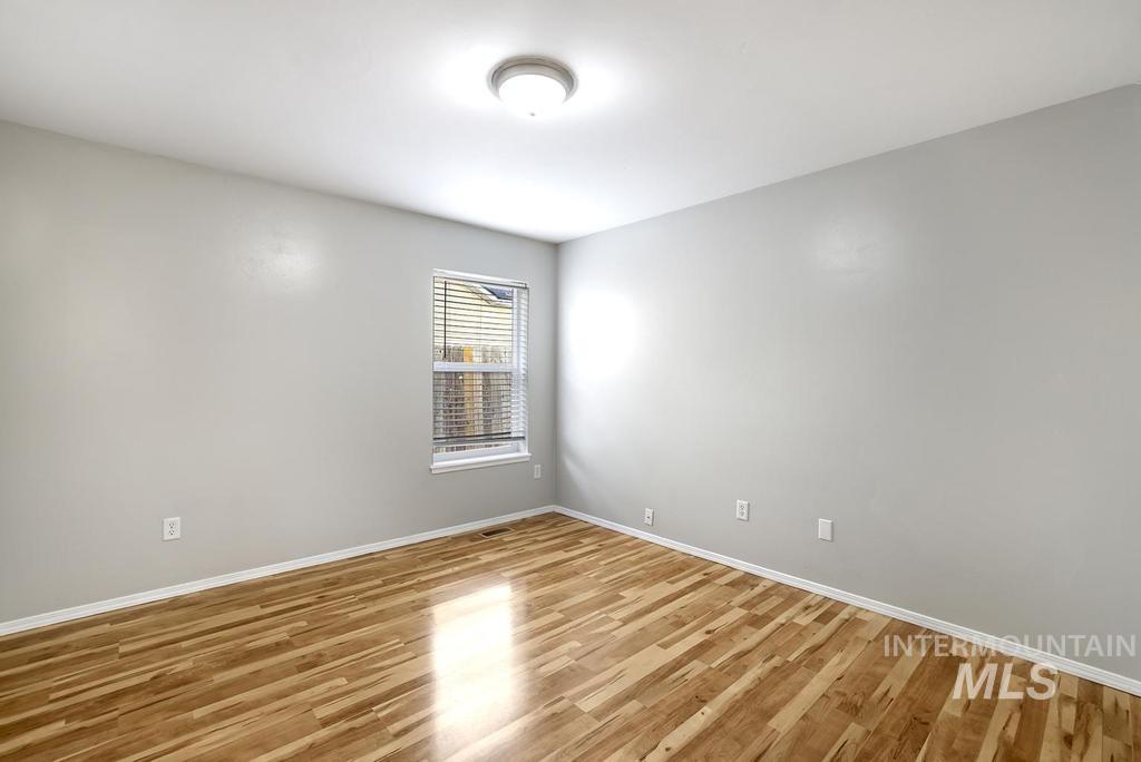 1393 Valencia Street Twin Falls, ID 83301 - Photo 12 of 44 Spare room featuring wood finished floors and baseboards
