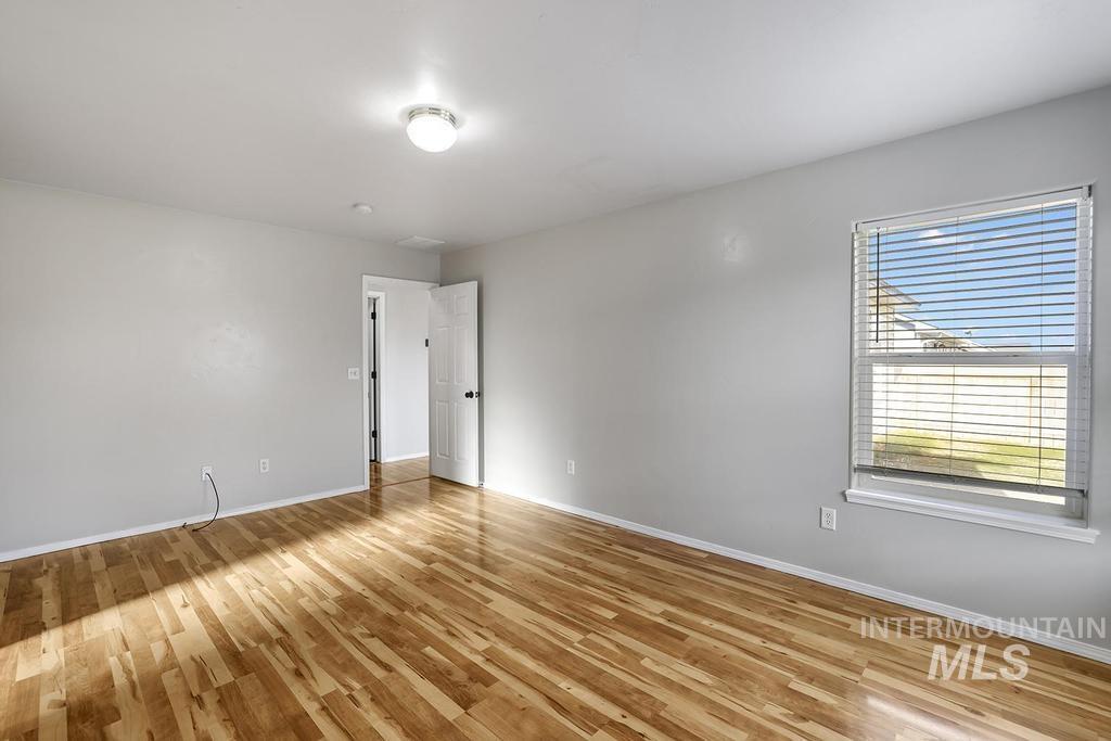 1393 Valencia Street Twin Falls, ID 83301 - Photo 16 of 44 Empty room with light wood-style flooring and baseboards