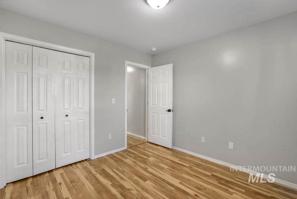 1393 Valencia Street Twin Falls, ID 83301 - Photo 20 of 44 Unfurnished bedroom featuring light wood finished floors and a closet