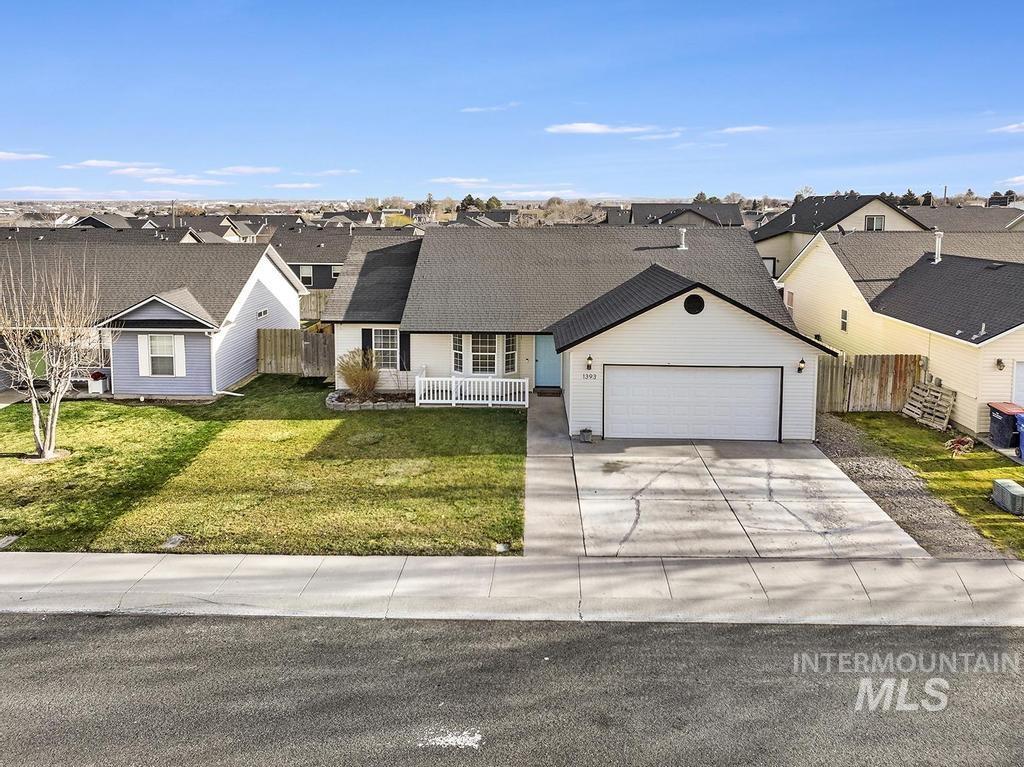 1393 Valencia Street Twin Falls, ID 83301 - Photo 37 of 44 View of front of house featuring a residential view, concrete driveway, and an attached garage