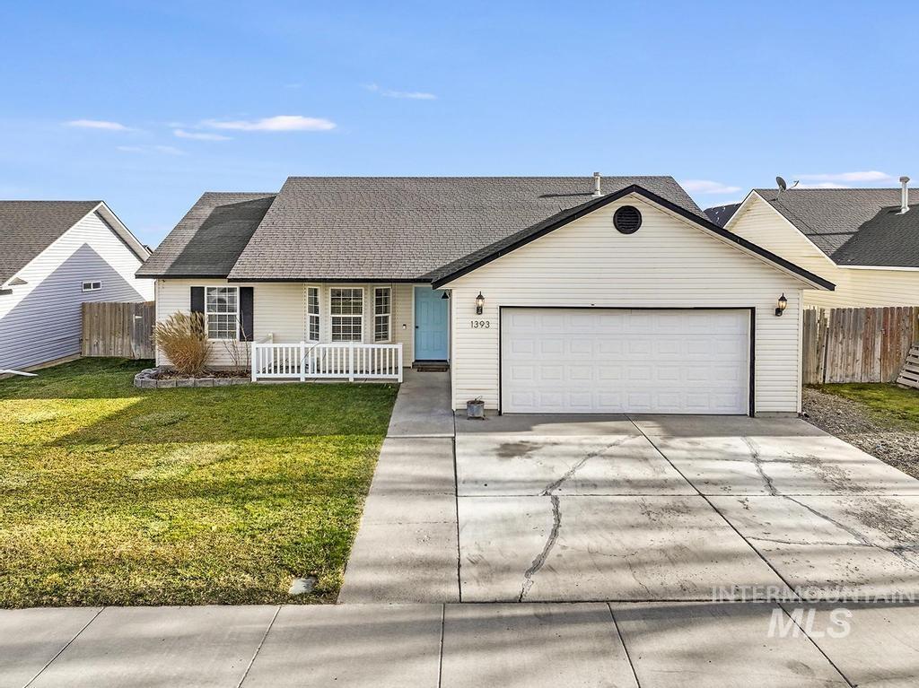 1393 Valencia Street Twin Falls, ID 83301 - Photo 39 of 44 View of front of house featuring driveway, roof with shingles, and a garage