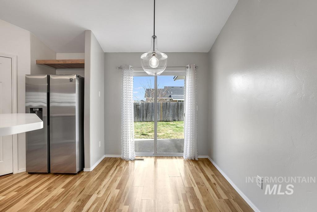 1393 Valencia Street Twin Falls, ID 83301 - Photo 9 of 44 Unfurnished dining area with light wood finished floors and baseboards