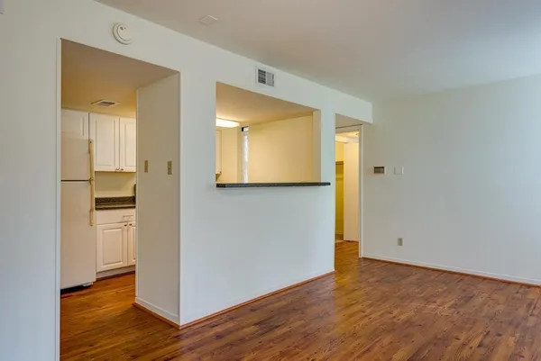 a view of a hallway with wooden floor