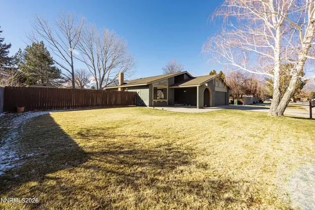 a view of a house with snow on the road