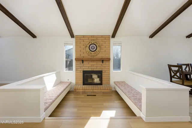 a view of a livingroom with an entryway and fireplace