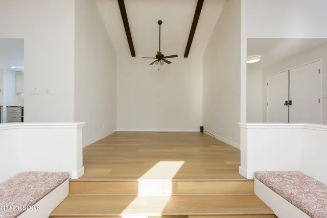 a dining hall with stainless steel appliances kitchen island a table and chairs in it