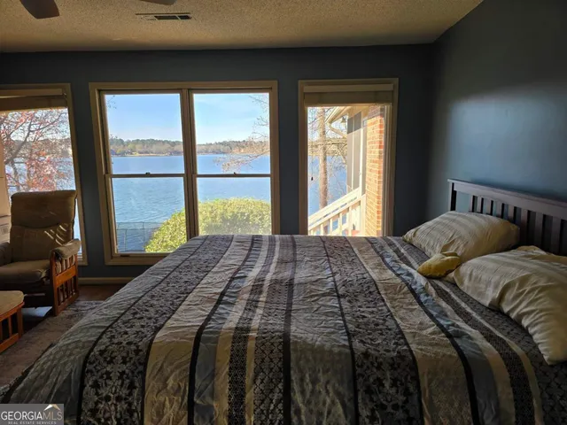 a bedroom with a bed and a large window