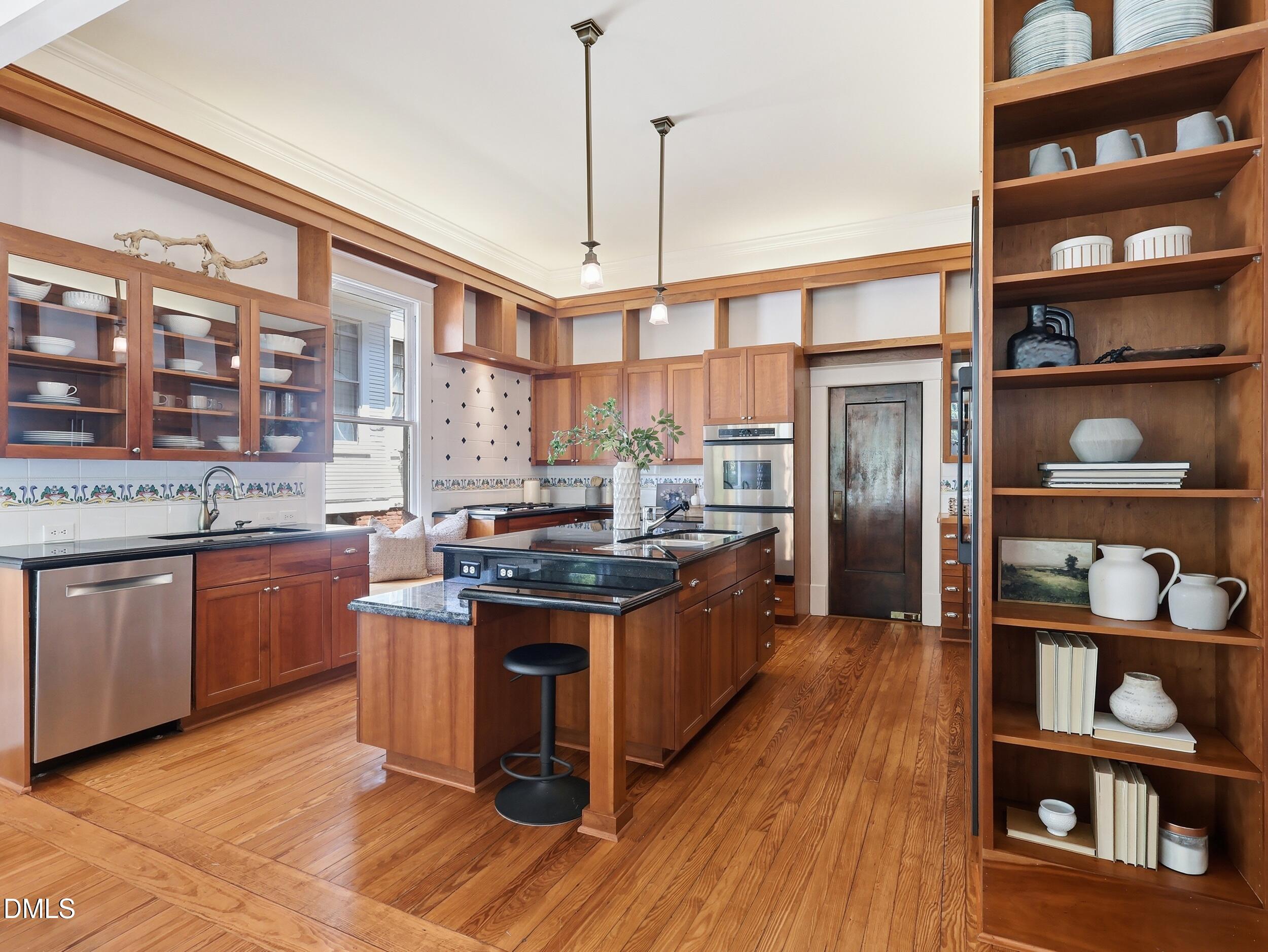 127 Forest Road Raleigh, NC 27605 - Photo 23 of 75 a kitchen with stainless steel appliances granite countertop a stove and a refrigerator