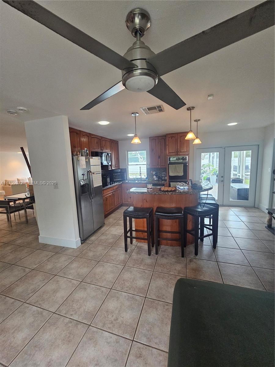 14461 Southwest 152nd Court Miami, FL 33196 - Photo 11 of 30 a living room with stainless steel appliances kitchen island granite countertop furniture and a kitchen view