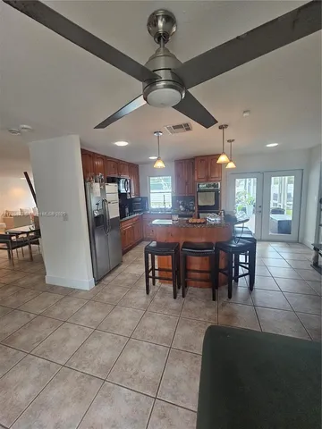a living room with stainless steel appliances kitchen island granite countertop furniture and a kitchen view