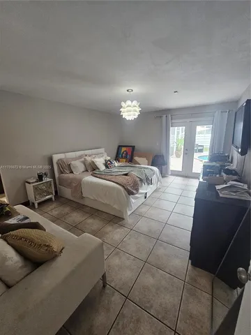 a bedroom with double bed and a couch