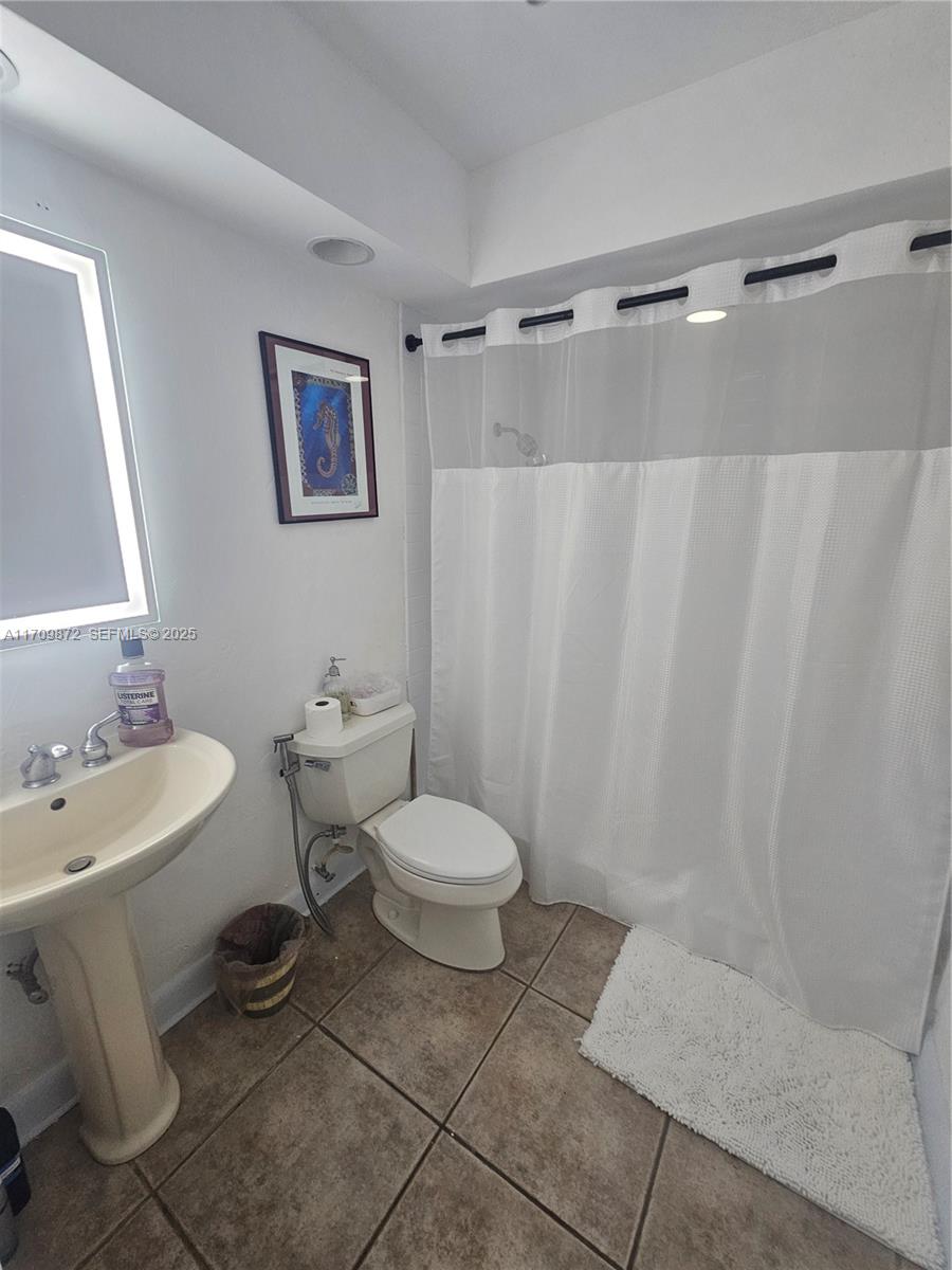 14461 Southwest 152nd Court Miami, FL 33196 - Photo 19 of 30 a bathroom with a toilet sink and shower