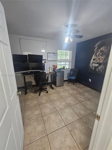 a living room with furniture a bed and a window