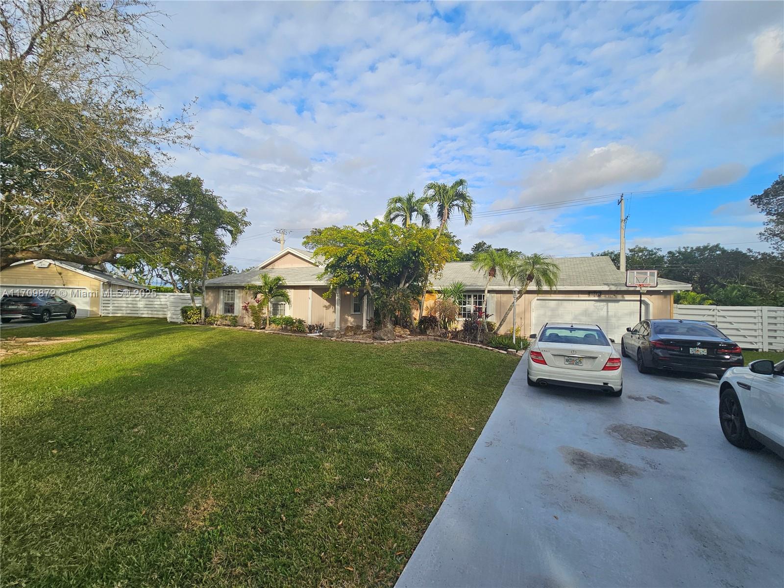 14461 Southwest 152nd Court Miami, FL 33196 - Photo 2 of 30 a view of street with parked cars
