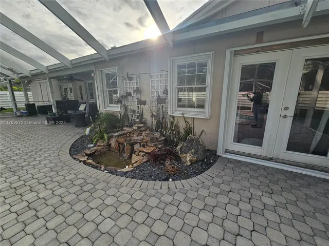 a view of a house with backyard and sitting area