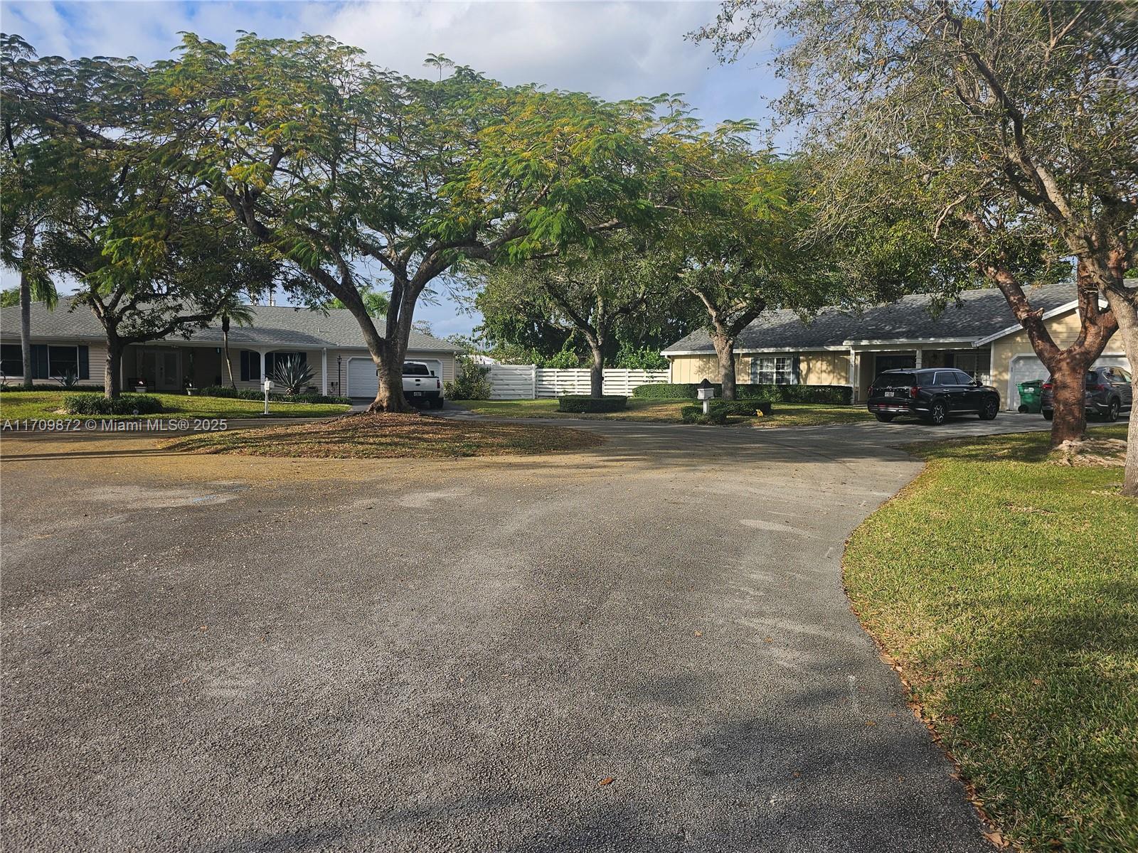 14461 Southwest 152nd Court Miami, FL 33196 - Photo 4 of 30 a view of a house with a yard and large trees