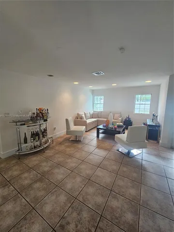 a living room with lots of furniture and a chandelier