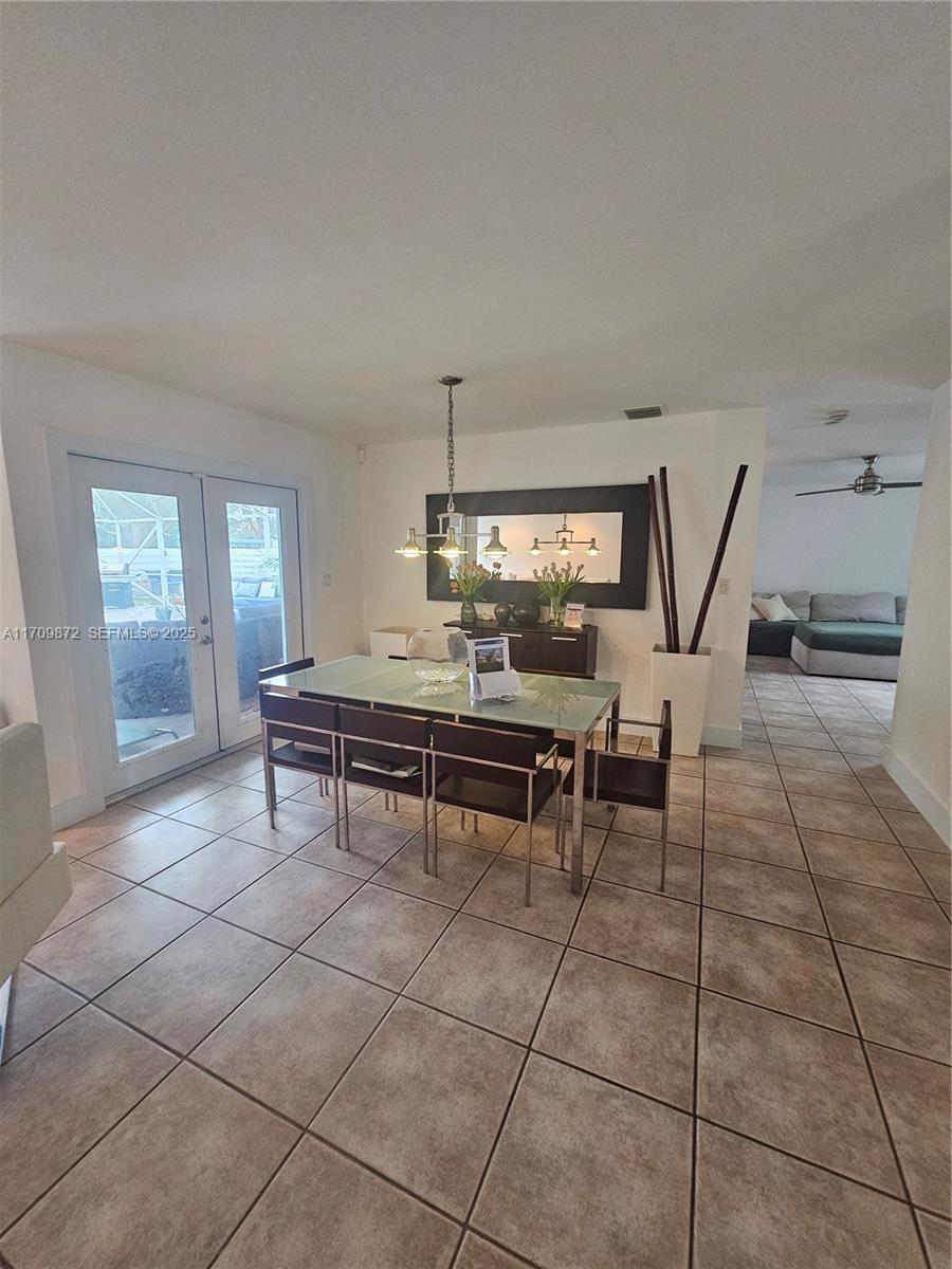 14461 Southwest 152nd Court Miami, FL 33196 - Photo 9 of 30 a living room with furniture a dining table and a large window