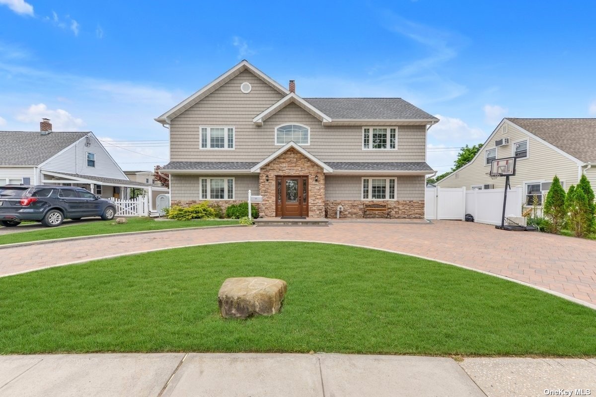 39 Valley Road Levittown, NY 11756 - Photo 1 of 1 a front view of a house with a garden and yard
