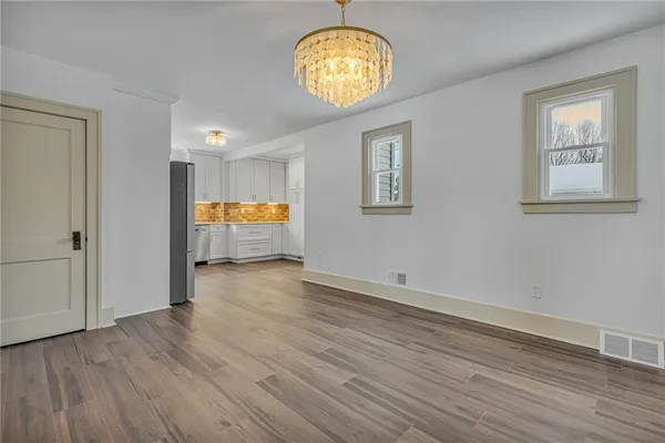 a view of room with wooden floor and window